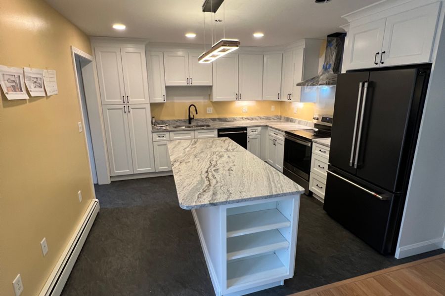 Finished kitchen remodel with updated cabinets, counters, and flooring