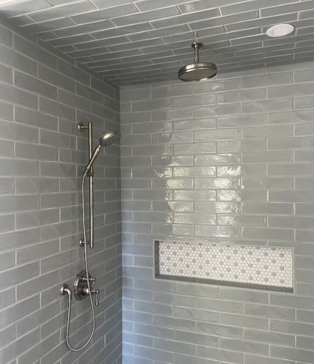 Bathroom shower remodel with clean tile and updated fixtures