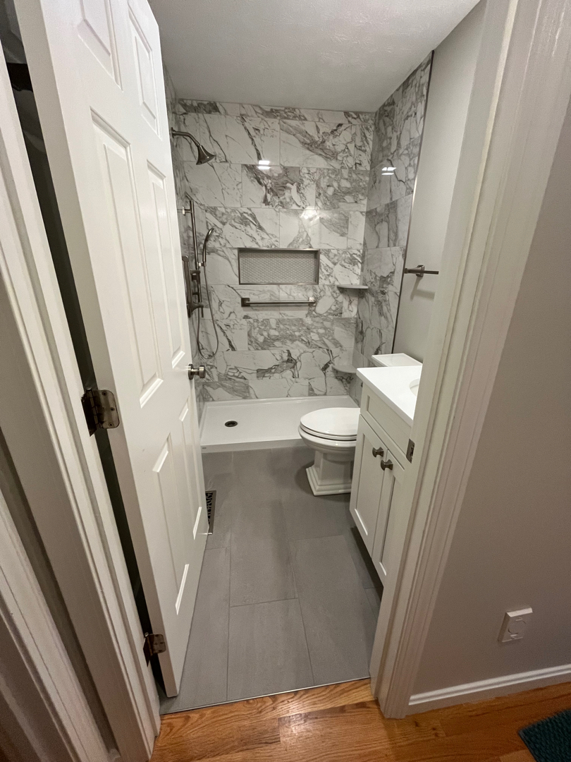 New wetwall system installed with walk-in shower and brushed nickel fixtures