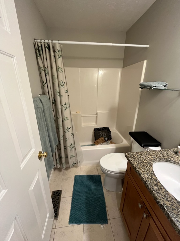 Shower before renovation with open framing and older materials