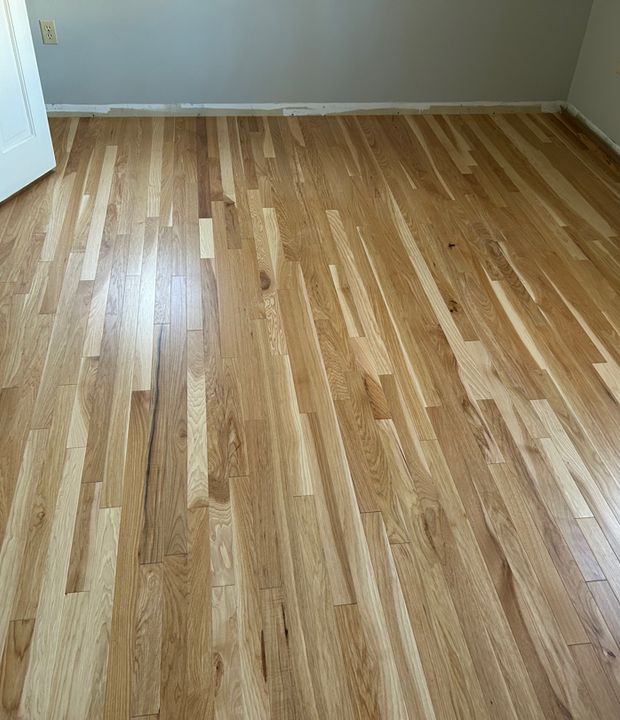 Newly installed natural hardwood flooring in a finished room